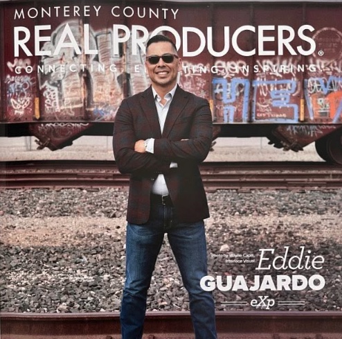 Monterey County Real Producers magazine cover featuring Eddie Guajardo standing beside a vintage railcar.